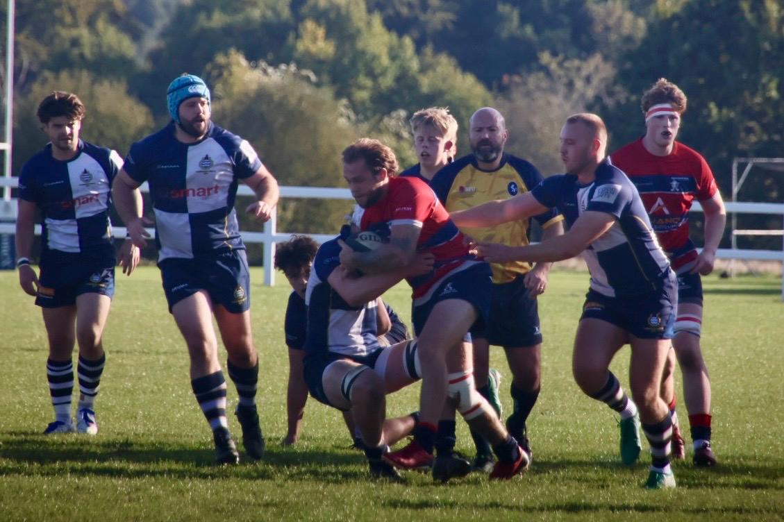 Addison Geer running with the ball into contact.