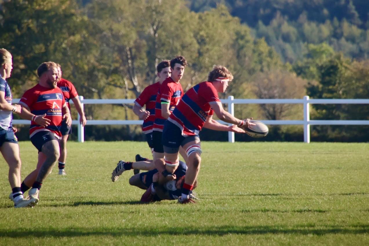 Cameron Parker offloading the ball as he comes into contact.