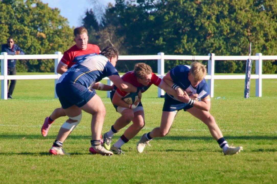 Fin Ashdown-Denney bracing for a tackle with the ball.