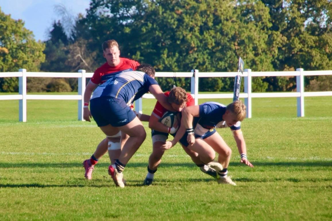 Fin Ashdown-Denney bracing for a tackle with the ball.
